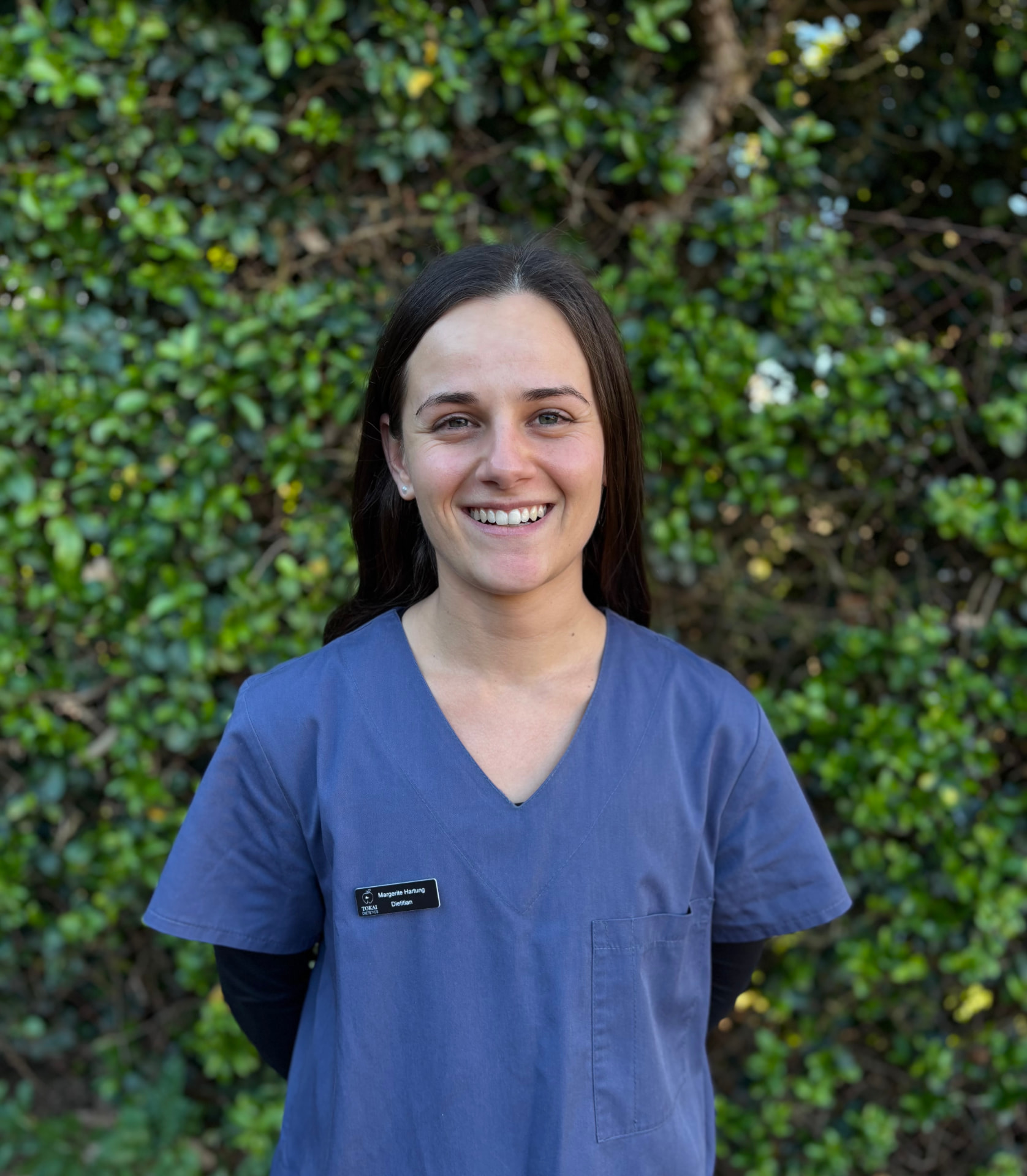 Margerite Hartung, clinical dietitian, in scrubs outdoors